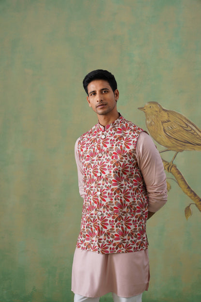 Man wearing a patterned kurta with a light green background