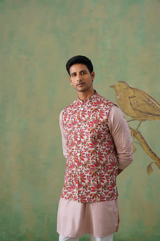 Man wearing a patterned kurta with a light green background