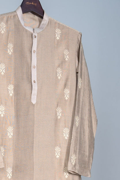 Orly beige cotton blend kurta with delicate white hand embroidery and subtle vertical stripes. Ideal for festive occasions.
