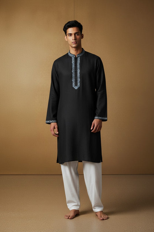 Orly black kurta set with blue floral hand embroidery on placket and cuffs. Lightweight fabric with woven texture.