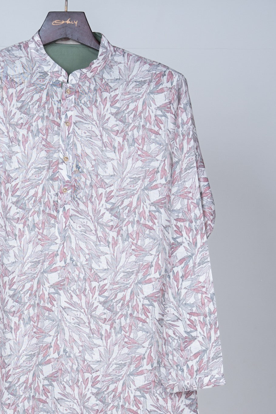 Orly ivory kurta with mauve and sage leaf print, contrast placket, and mandarin collar. Ideal for festive occasions.