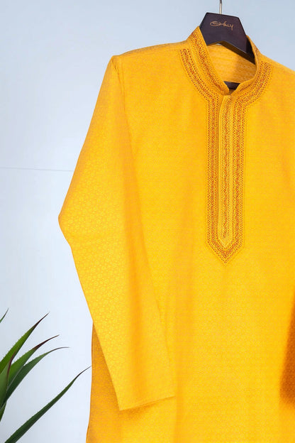 Orly mustard yellow cotton silk jacquard kurta with woven motifs and hand-embroidered neckline, suitable for festive wear.